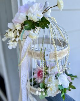 Shabby Chic romantic bird cage with flowers and candles